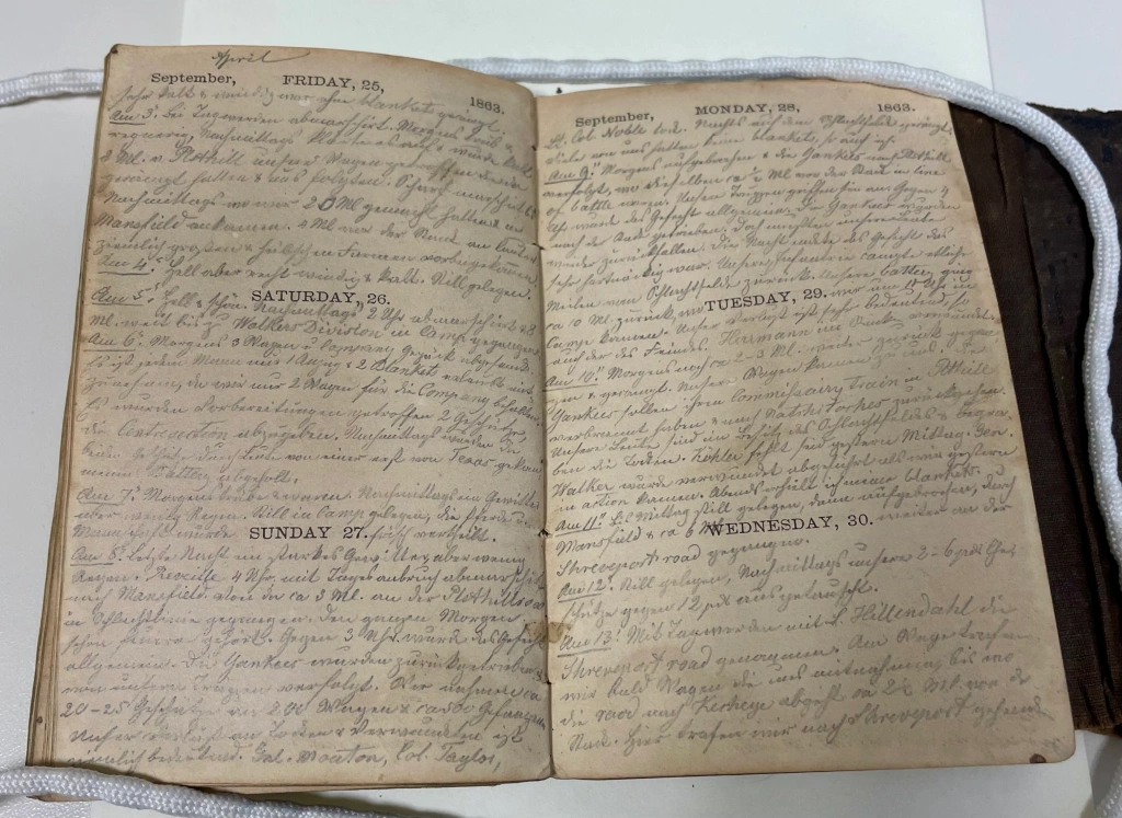 image of a small journal with handwritten entries for the year 1863
